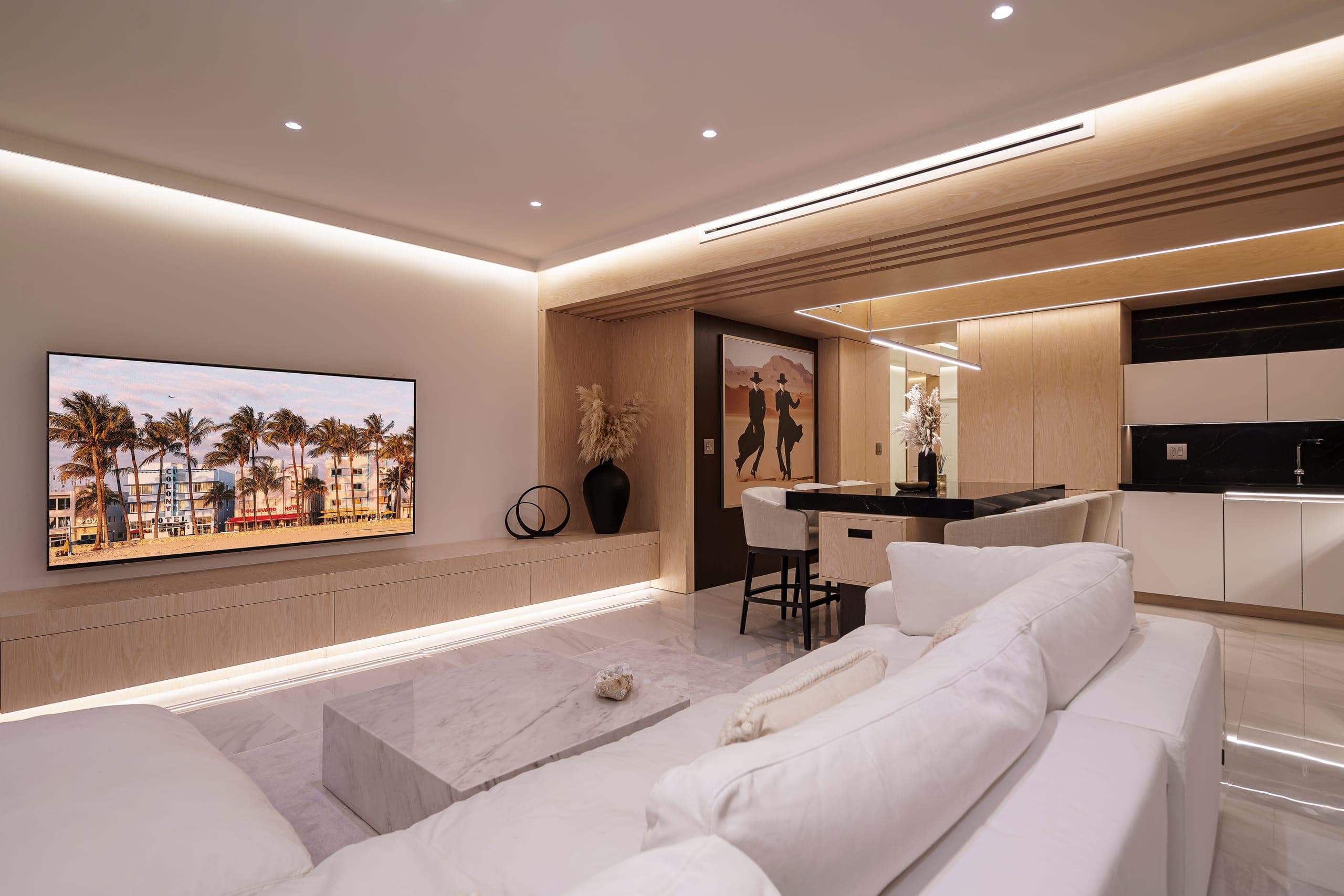 Floor-to-ceiling built-in media wall with integrated TV and hidden storage