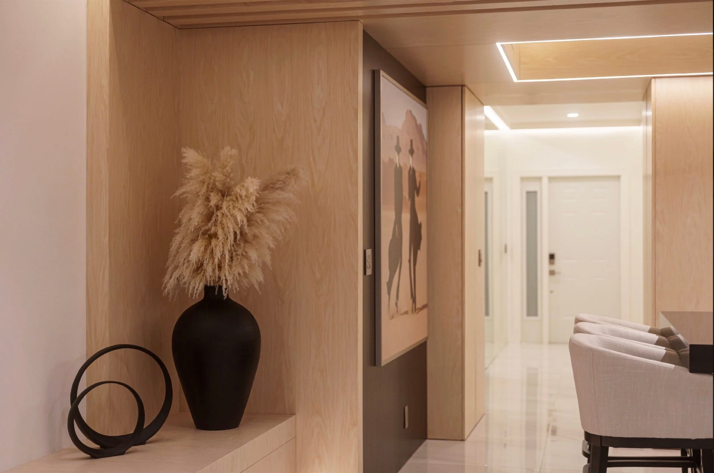 Walk-in closet with island, integrated lighting, and oak veneer cabinetry