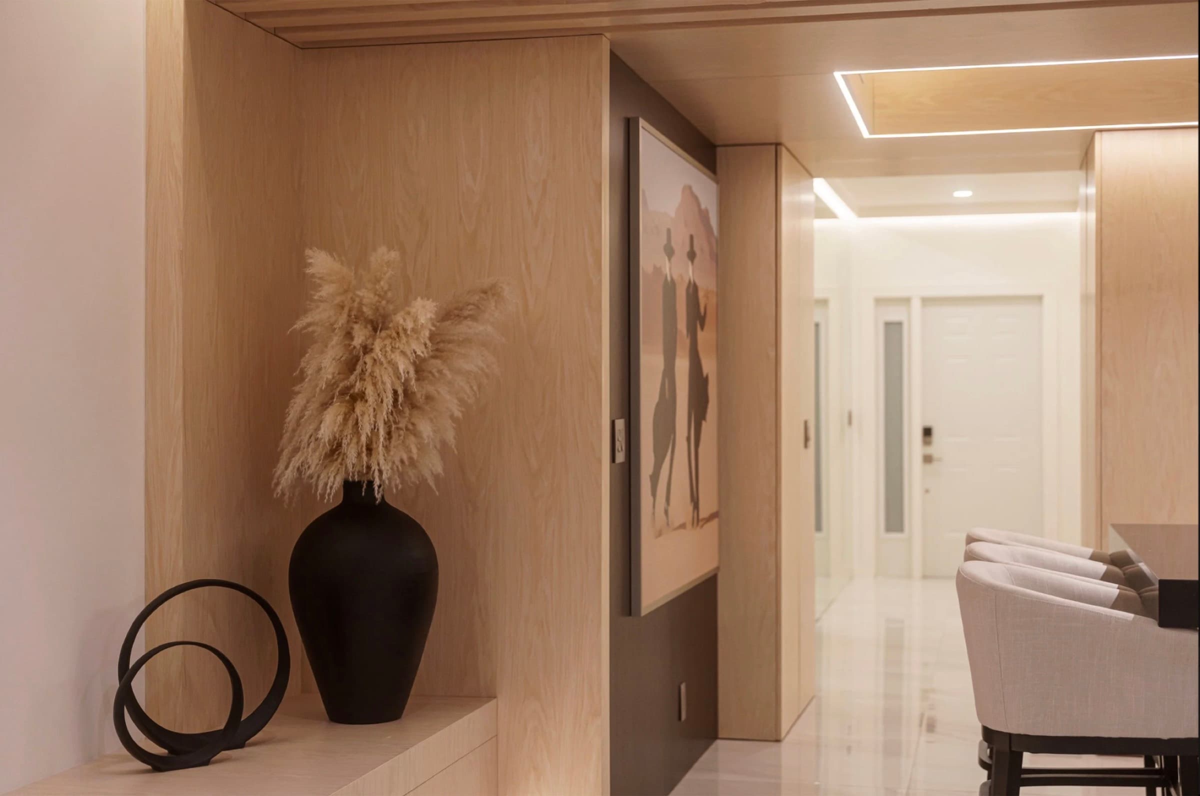 Walk-in closet with island, integrated lighting, and oak veneer cabinetry
